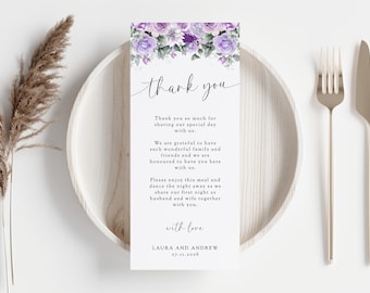 May include: A white thank you card with purple flowers at the top. The text reads "thank you" in a script font. The card includes a message thanking guests for attending the wedding and sharing their special day. The card is signed "with love, Laura and Andrew" and includes the date "27.11.2026".