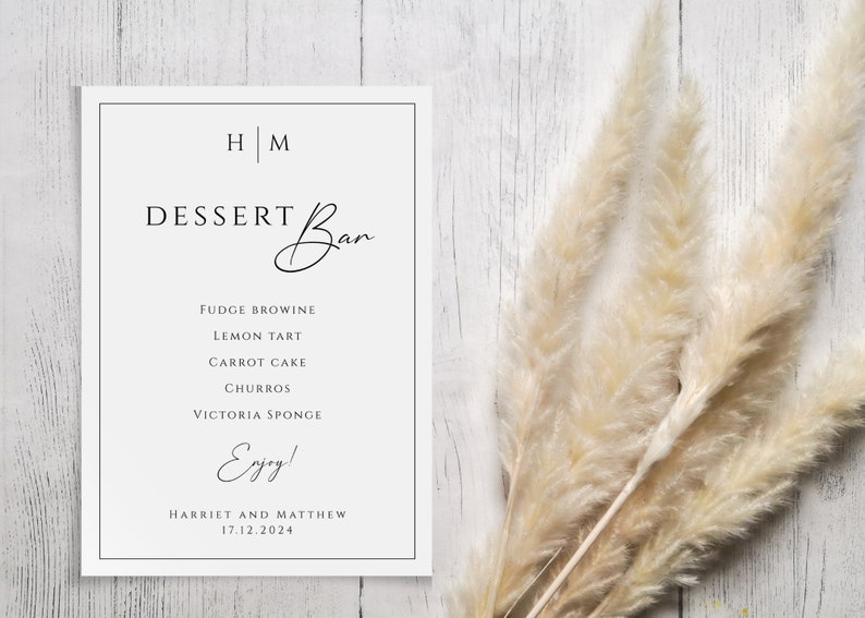 May include: A white sign with black text announcing a dessert bar with the names "Harriet and Matthew" and the date "17.12.2024". The sign lists the following desserts: Fudge Brownie, Lemon Tart, Carrot Cake, Churros, and Victoria Sponge.
