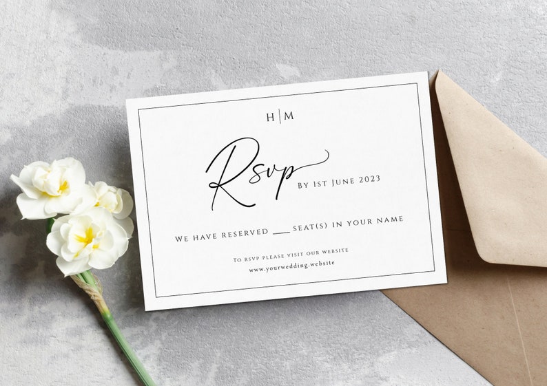May include: A white RSVP card with black text. The text reads "HM RSVP by 1st June 2023. We have reserved ____ seat(s) in your name. To RSVP please visit our website www.yourwedding.website."