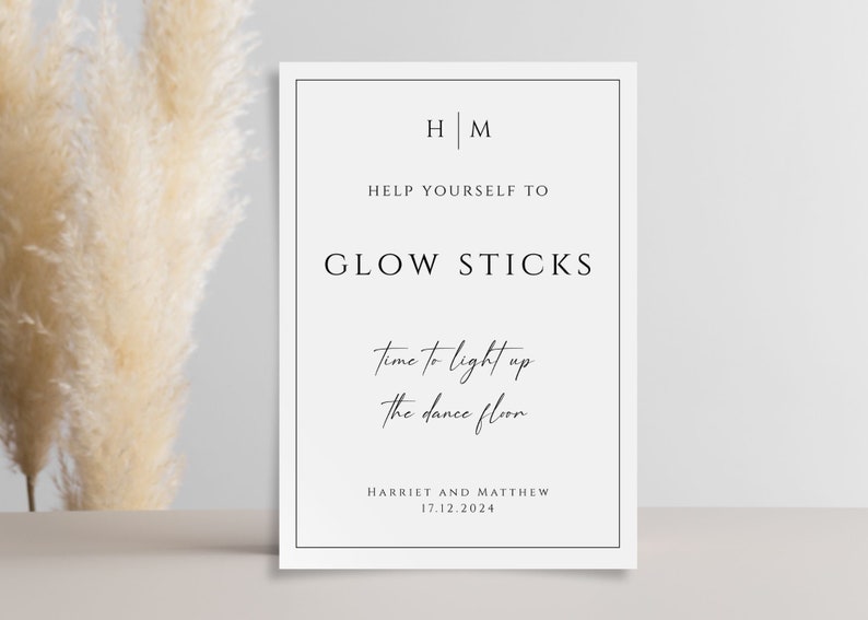 May include: A white sign with black text that reads "HM Help Yourself To Glow Sticks Time to light up the dance floor Harriet and Matthew 17.12.2024"