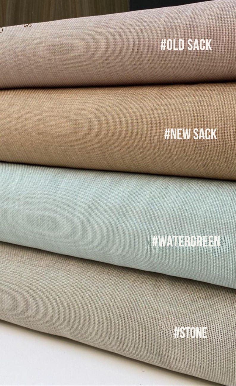 May include: Close-up of four fabric samples in various neutral colors. The top sample is a dusty rose, followed by tan, a light blue-green, and a beige color. Each sample has a textured weave. Text labels include #OLD SACK, #NEW SACK, #WATERGREEN, and #STONE.
