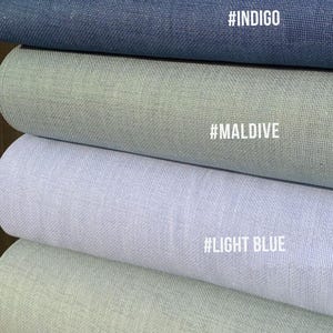 May include: A stack of fabric rolls in various shades of blue and green. The colors include petroleum blue, indigo, maldives, light blue, and nile. Each roll has a corresponding color name in white text.