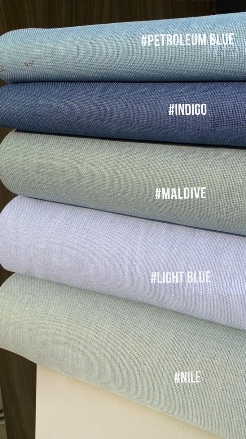 May include: A stack of fabric rolls in various shades of blue and green. The colors include petroleum blue, indigo, maldives, light blue, and nile. Each roll has a corresponding color name in white text.