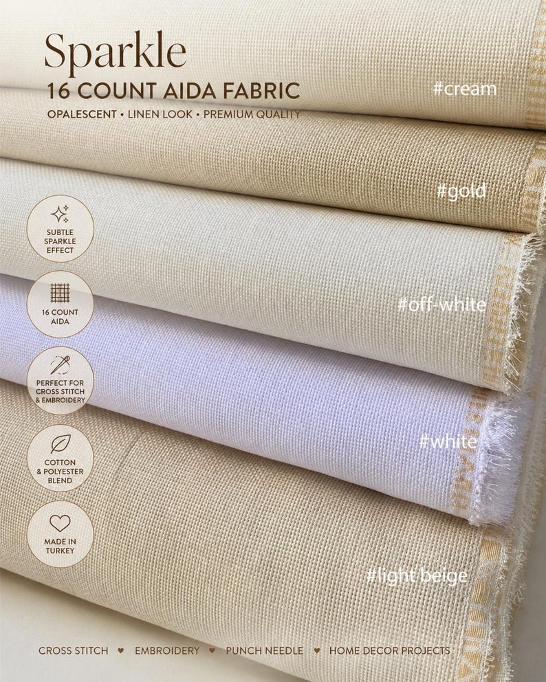 May include: Close-up of stacked rolls of 16 count Aida fabric in various shades, including cream, gold, off-white, white, and light beige. The fabric has a linen look and is opalescent. Text on the image reads "Sparkle" and "Perfect for cross stitch & embroidery."