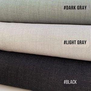May include: Three rolls of fabric in varying shades of gray and black. The top roll is dark gray, the middle is light gray, and the bottom is black. Each roll has a textured appearance. Text on the rolls reads: #DARK GRAY, #LIGHT GRAY, and #BLACK.