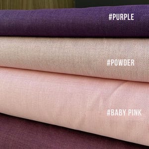 May include: Close-up of four fabric swatches in shades of purple, powder, baby pink, and damson. Each swatch has a textured appearance and a corresponding color name in white text: #PURPLE, #POWDER, #BABY PINK, and #DAMSON.