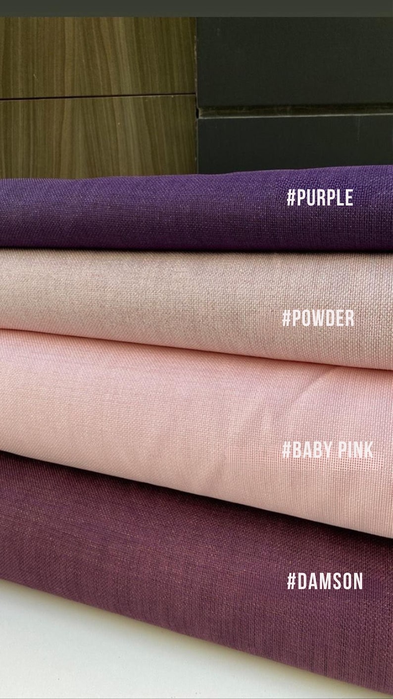 May include: Close-up of four fabric swatches in shades of purple, powder, baby pink, and damson. Each swatch has a textured appearance and a corresponding color name in white text: #PURPLE, #POWDER, #BABY PINK, and #DAMSON.