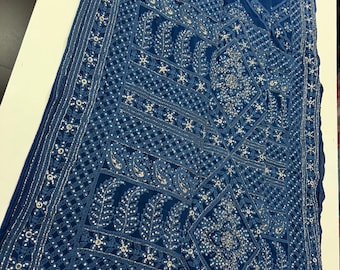 This elegant Pure Georgette Chikankari saree features intricate hand-embroidered floral patterns with exquisite stone work and cutdana