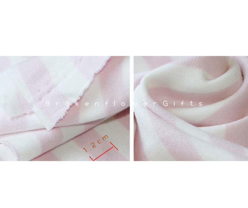 May include: Close-up of a soft, pink and white striped fabric. The fabric is folded and draped, showing the texture and pattern. The stripes are approximately 1.2 cm wide. The text "Brokenflower Gifts" is visible.