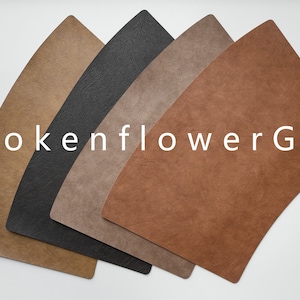 May include: Five leather placemats in different colours: brown, dark brown, grey, black, and light brown. The placemats are arranged in a fan shape. The text "BrokenflowerGift" is visible in the image.