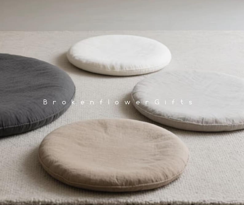 May include: Four round floor cushions in different colors and fabrics. The cushions are made of a soft, textured material and are perfect for adding a touch of comfort and style to any room.