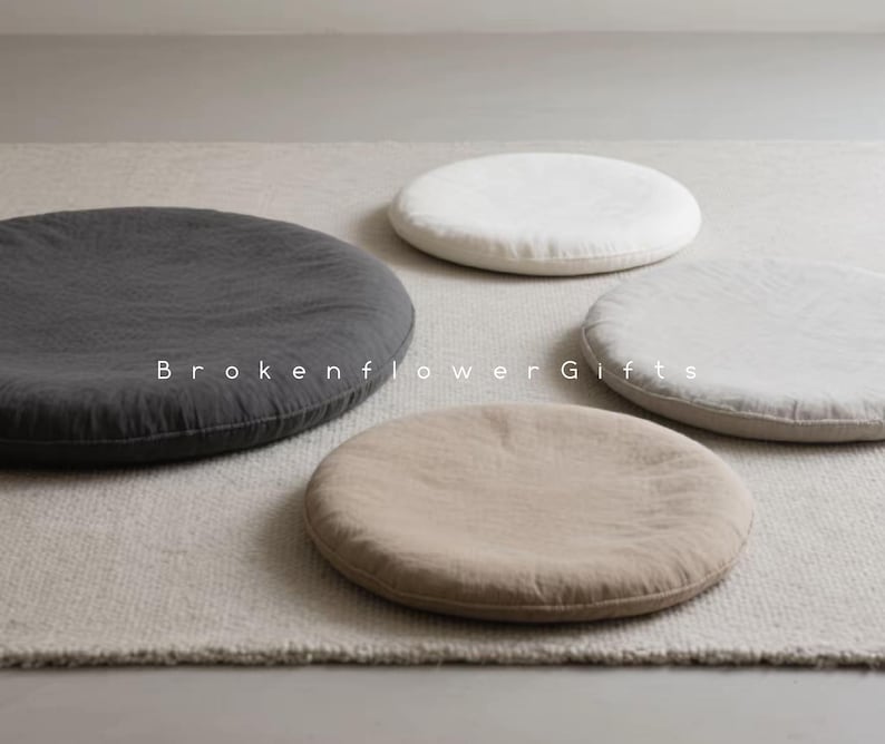 May include: Four round floor cushions in different colors and fabrics. The cushions are made of a soft, natural material and are perfect for adding a touch of comfort and style to any room.