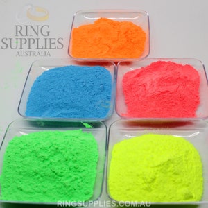 May include: Five small, clear square dishes each filled with a different color of powder. The colors are orange, blue, pink, green, and yellow. The text "RING SUPPLIES AUSTRALIA" is in the upper left corner. The text "RINGSUPPLIES.COM.AU" is in the bottom right corner.