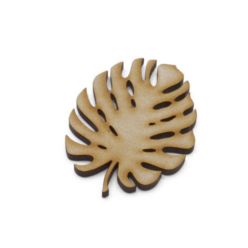 May include: A wooden cutout of a tropical monstera leaf. The leaf is light brown and has a detailed design.