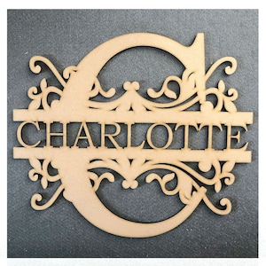 May include: Wooden cutout of the letter C with decorative swirls and the name "CHARLOTTE" written across the center.