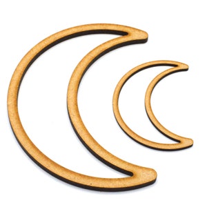 May include: Two wooden crescent moon shapes, one larger than the other, are stacked on top of each other. The moons are a light brown colour and have a smooth, polished finish.