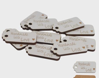 May include: A collection of small, rectangular wooden tags with rounded edges and a hole for stringing. Each tag is cream-colored with brown edges and features the words "Handmade With Love" in a handwritten style, along with a small heart.