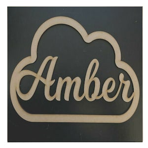May include: Wooden cloud-shaped sign with the name "Amber" written in a cursive font.