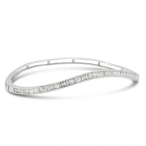 May include: A silver-toned bangle bracelet with a wave design. The bracelet is encrusted with rectangular-cut, clear gemstones. The bracelet is set against a white background.