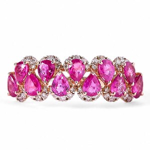May include: A rose gold ring featuring a series of vibrant pink teardrop-shaped gemstones, each surrounded by a halo of smaller, clear stones. The ring's design is symmetrical, with the gemstones arranged in a repeating pattern.