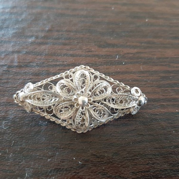 Vintage Italian silver filigree pin flower in a diamond shape background