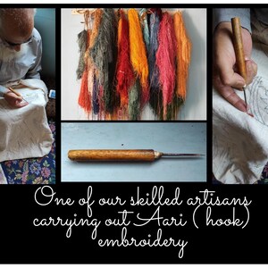 May include: A close-up of a skilled artisan using a hook to create a traditional Ari embroidery design. The artisan is working on a white fabric with a floral pattern. The image also shows a variety of colorful threads and a wooden hook.