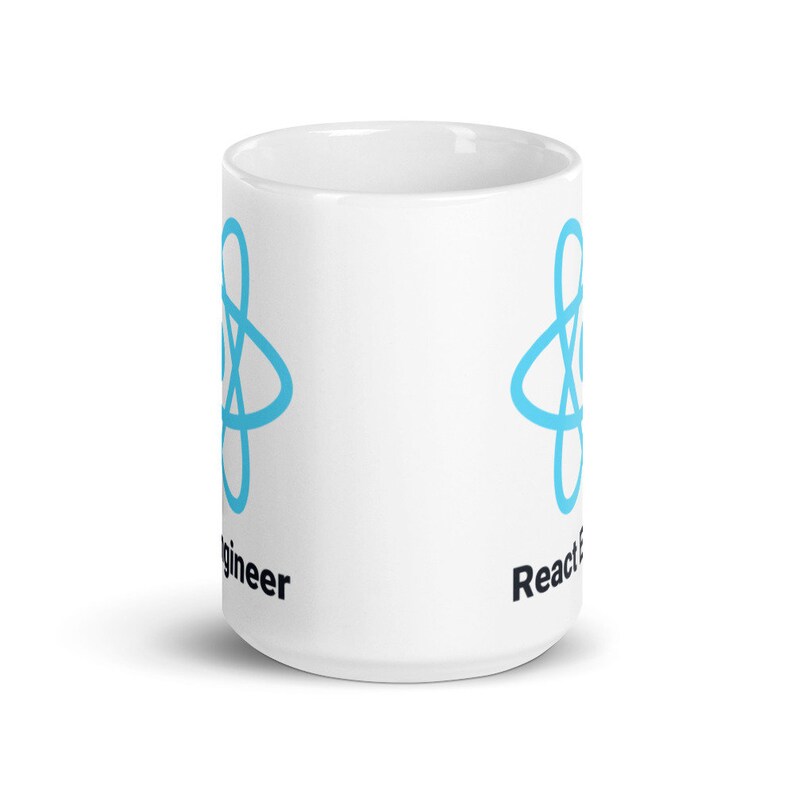 May include: White ceramic mug featuring a light blue atom symbol and the words "React Engineer". The mug has a cylindrical shape and a glossy finish. The design is repeated on both sides.