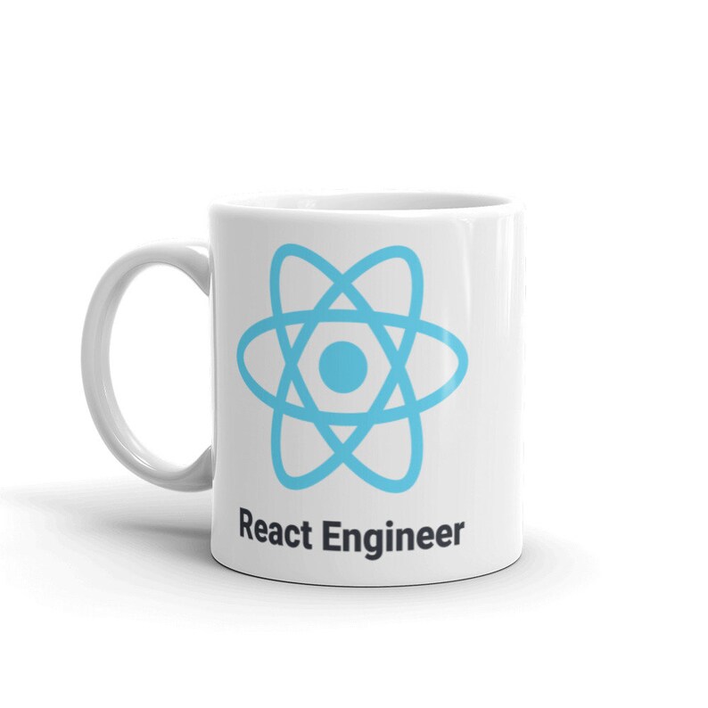 May include: White ceramic mug featuring a light blue atom symbol and the text "React Engineer" in black. The mug has a curved handle, suitable for hot drinks.