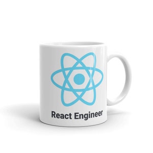May include: White ceramic mug featuring a light blue atom symbol and the text "React Engineer" in black. The mug has a curved handle. Ideal for a software developer. The mug is set against a white background.