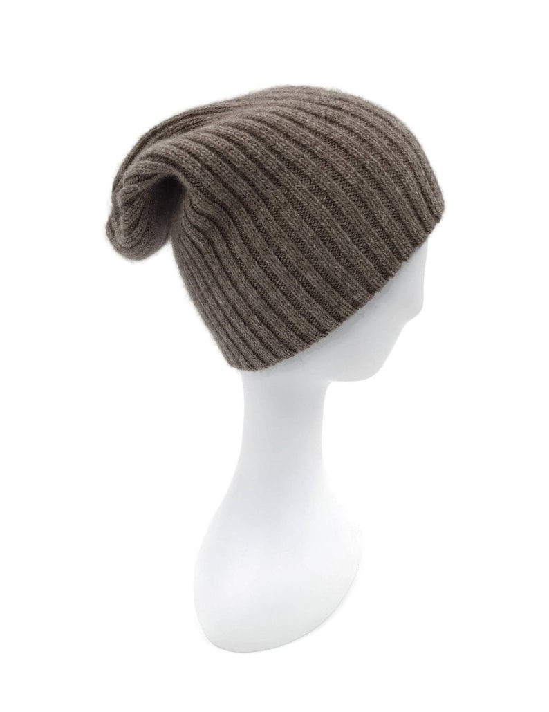 May include: A brown ribbed knit beanie hat on a white mannequin head.