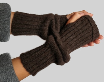 May include: Brown knitted fingerless gloves with a fold-over cuff. The gloves are made of a soft, warm material and are perfect for keeping your hands warm in the winter.