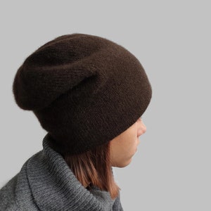 May include: A brown slouchy beanie hat made of soft knit fabric.