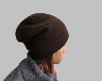 May include: A brown slouchy beanie hat made of soft knit fabric.