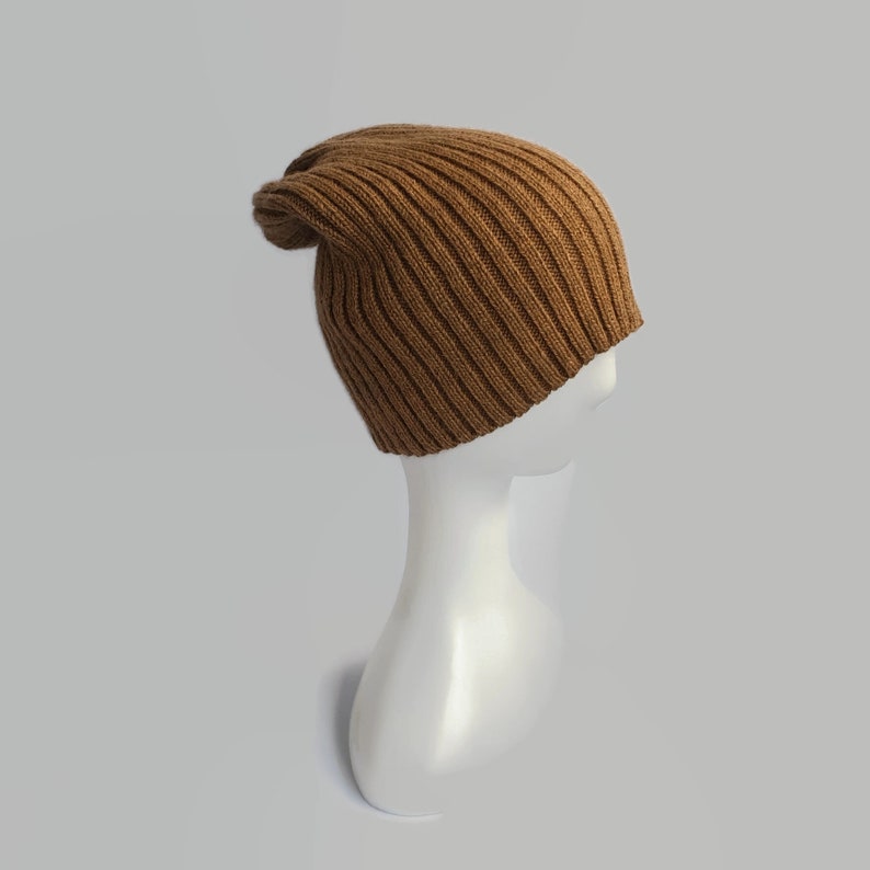 May include: A brown ribbed knit beanie hat on a white mannequin head.
