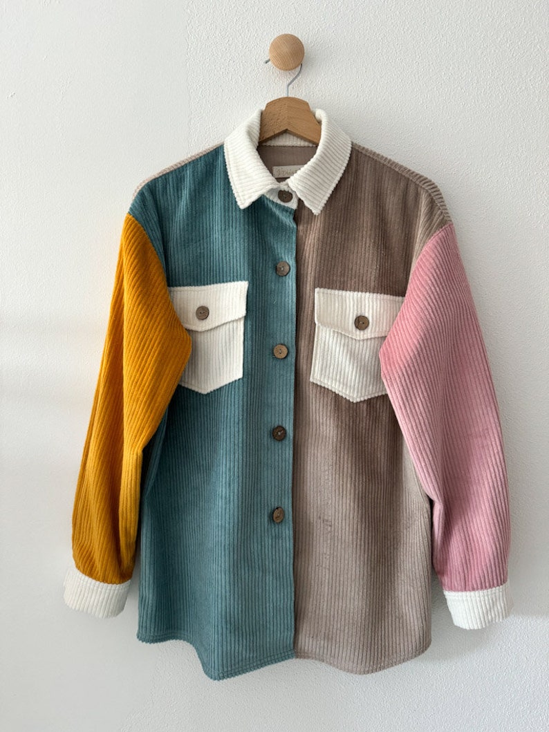 May include: A multi-colored corduroy shirt with a button-up front and long sleeves. The shirt is made of a patchwork of different colors, including teal, brown, white, and yellow.