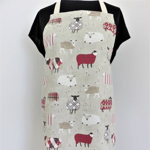 Handmade fabric apron in cotton with sheep in woolly jumpers print.  Pretty cooking apron, pinafore, craft or baking apron for busy people.