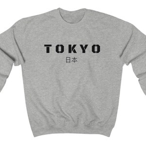 May include: A gray sweatshirt with black text that reads "TOKYO 日本".