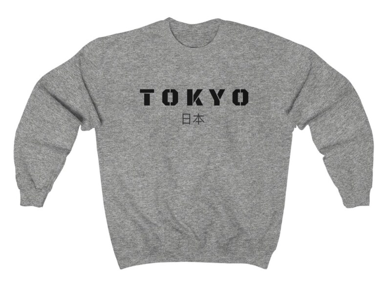 May include: A heather gray sweatshirt with the word "TOKYO" in black block letters and the Japanese word for Japan, "日本", underneath.