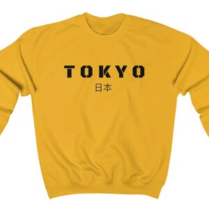 May include: A yellow sweatshirt with black text that says "TOKYO 日本".