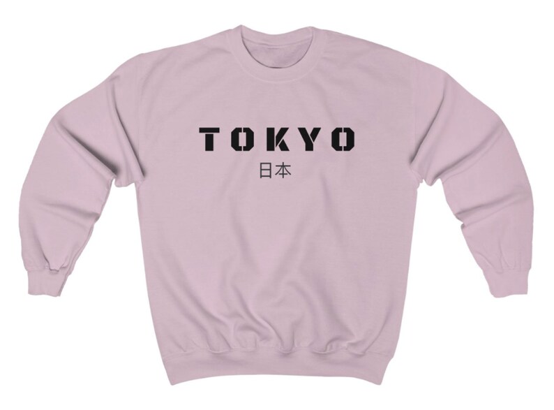 May include: A light pink sweatshirt with the word "TOKYO" in black block letters and the Japanese word for Japan, "日本", underneath.