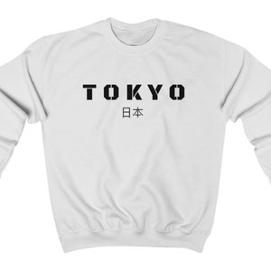 May include: White sweatshirt with black text that reads "TOKYO 日本" (Japan in Japanese).