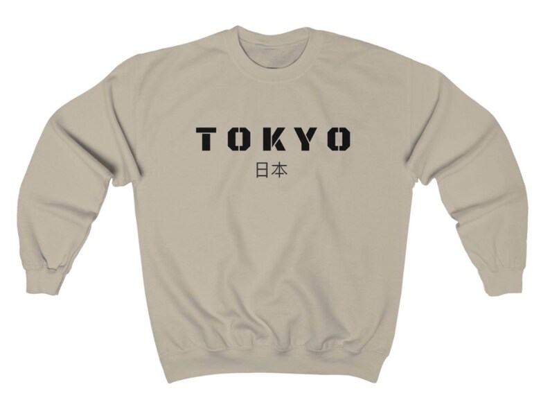 May include: A beige sweatshirt with black text that reads "TOKYO 日本".