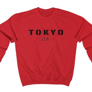 May include: Red sweatshirt with black text that says "TOKYO" and "日本" in Japanese characters.