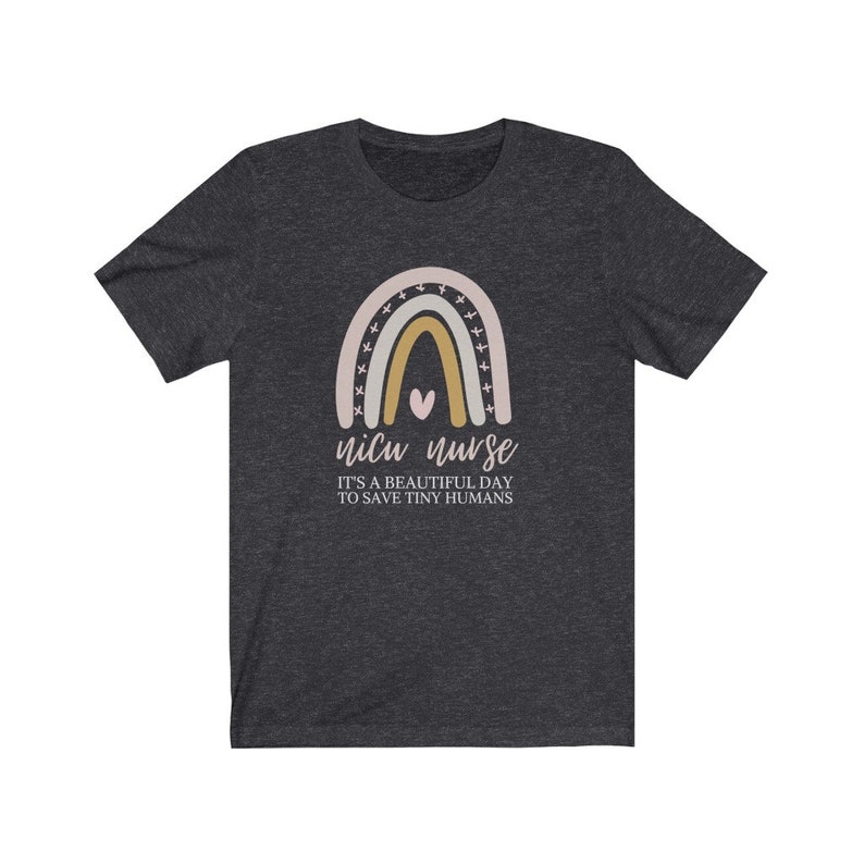 May include: A dark heather grey t-shirt with a rainbow graphic and the text "NICU nurse it's a beautiful day to save tiny humans".