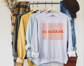 May include: Gray sweatshirt with the text "MS WARRIOR" repeated five times in orange, in a retro font style.