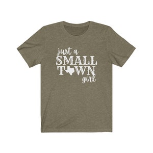 May include: A green t-shirt with the text "just a small town girl" and an outline of the state of Texas.