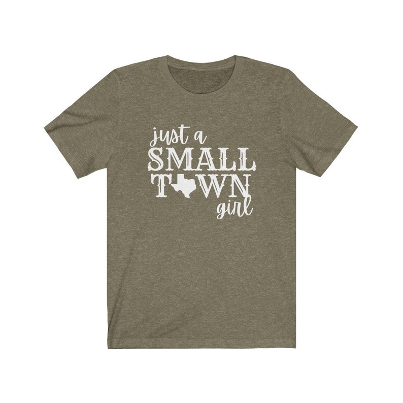 May include: A green t-shirt with the text "just a small town girl" and an outline of the state of Texas.