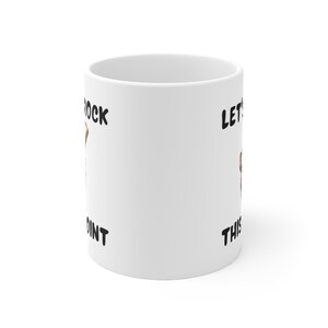 May include: White ceramic mug with black text that reads "Let's Rock This Joint".