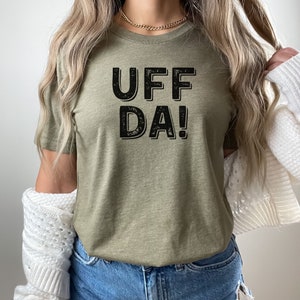 May include: A green t-shirt with the text "UFF DA!" printed in black.
