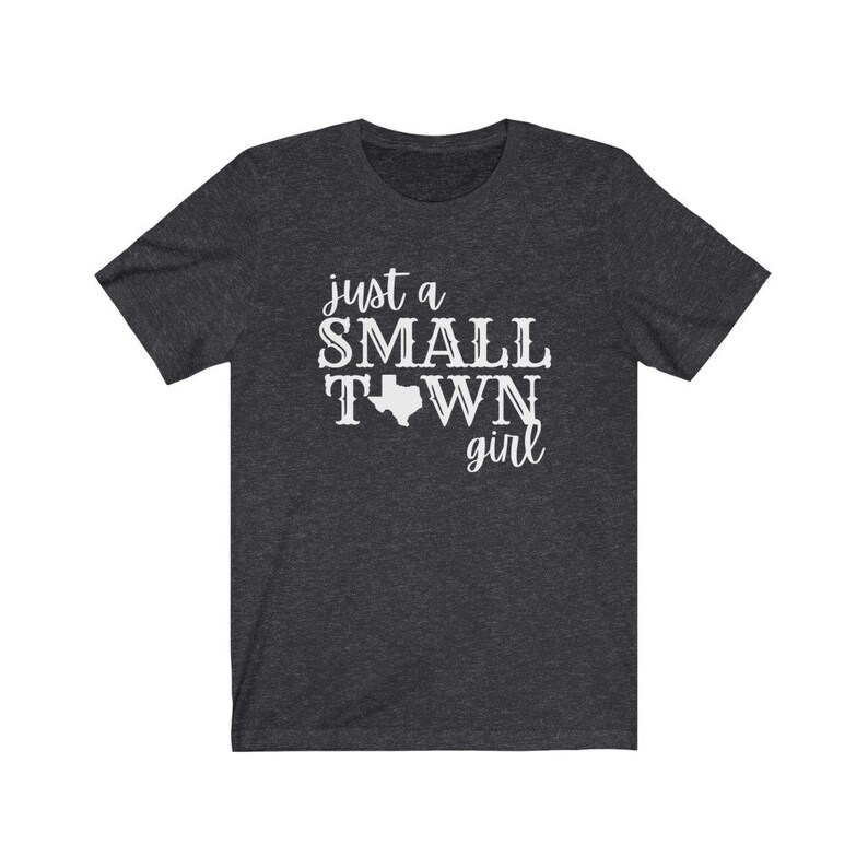 May include: A dark heather grey t-shirt with the text "just a small town girl" and an outline of the state of Texas.